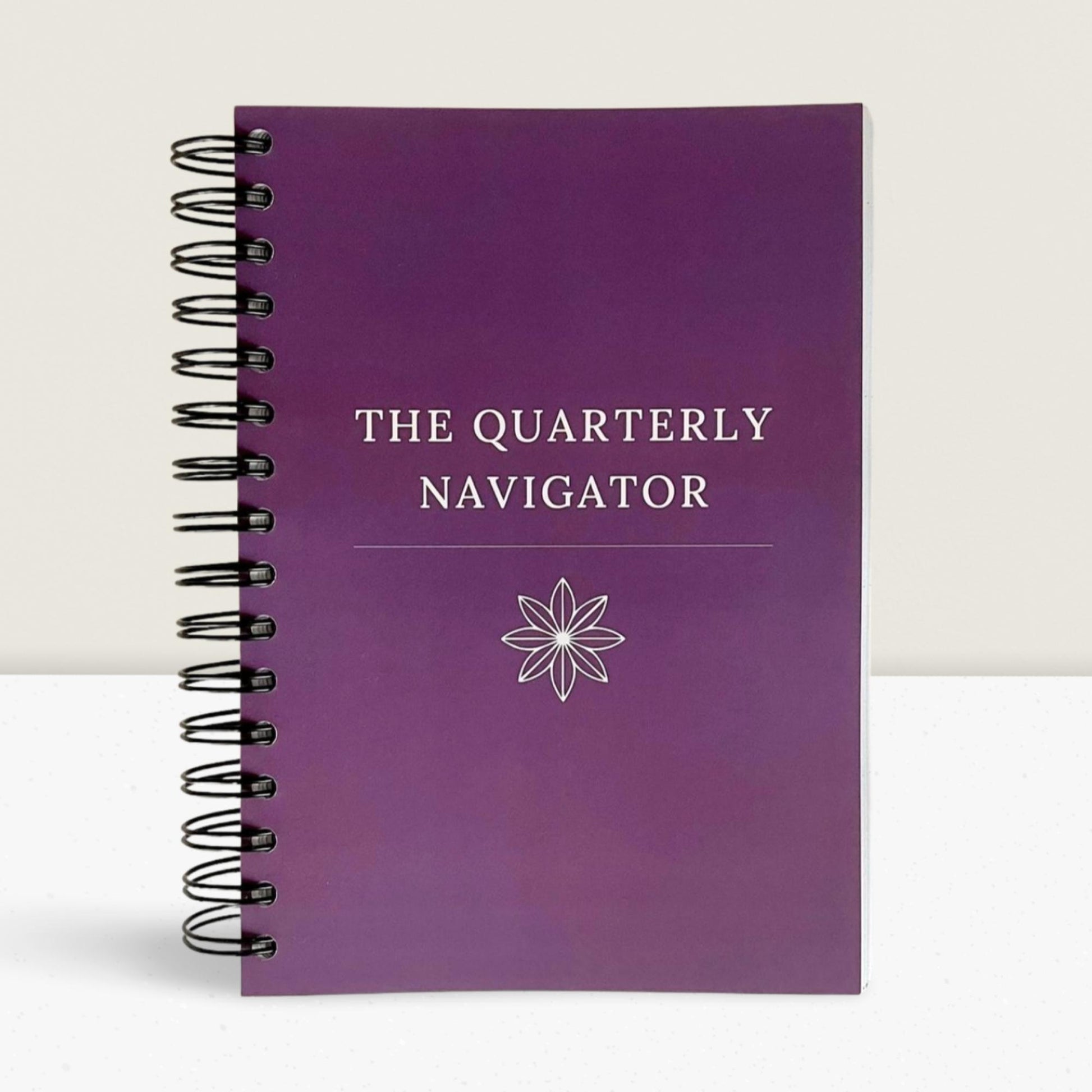 The Quarterly Navigator productivity planner by Agile Bloom- A purple plum cover flatlay